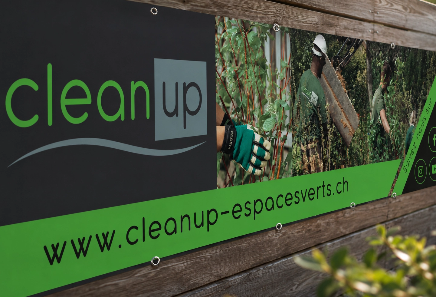 Détail de l’impression d’une banderole publicitaire Clean Up avec photos paysagères, logo vert et noir et finition grand format.